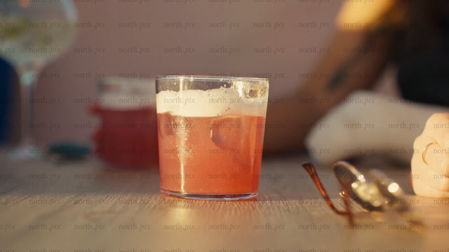 Friends enjoying cocktails at sunset during summer in the city