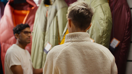 Couple Choosing a Sleeping Bag in a Camping Store