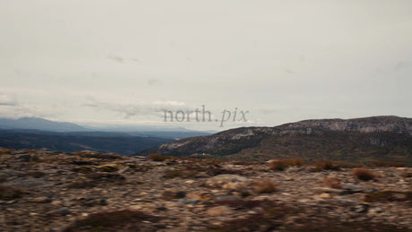 Mountain Biker Rides Downhill on Rocky Ridge