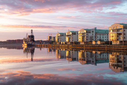 Harbor waterfront with residential buildings at sunrise