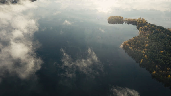 Misty lake and autumn forest at sunrise