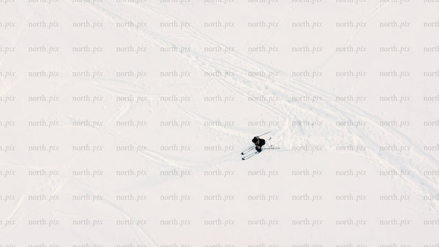 Aerial view of skiing downhill on snowy slope in riksgransen