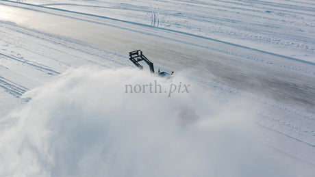 Snow Blower Clearing Snowy Road in Winter, Lulea, Sweden - Aerial Drone Footage