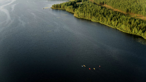 Kayakers on a summer day in Luleå: A drone's eye view of lake and forest