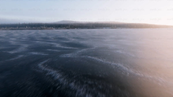 Frozen lake in arvidsjaur, Sweden: Winter sunset drone view