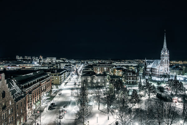Night aerial view of snowy city with church