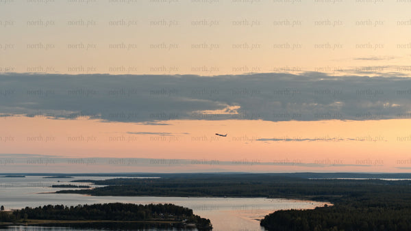 Aerial sunset view of Luleå archipelago: Plane soaring over calm waters