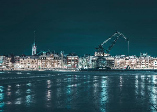 Night waterfront with industrial crane and church steeple