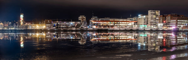 City harbor at night with waterfront building reflections