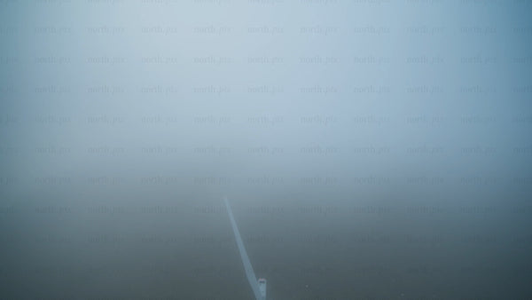 Wind turbine emerging from fog: Aerial view of renewable energy in Haraholmen