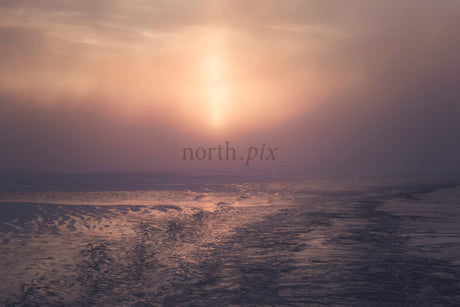 Misty Pastel Sunset Over Frozen Tidal Flats Reflecting Light on Low Tide Beach at Dusk