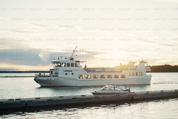 Sunset cruise boat near Luleå city center harbor with passengers