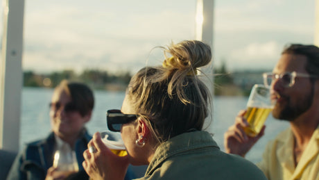 Friends Enjoying Drinks on a Boat in Luleå at Sunset