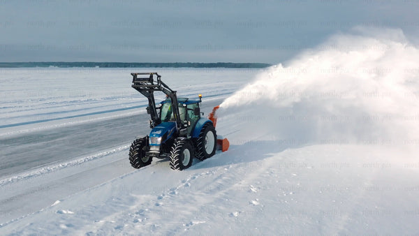 Tractor clearing snow on a frozen lake in Luleå during winter