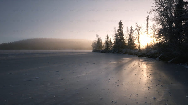 Winter sunrise over a frozen lake in arvidsjaur, Sweden