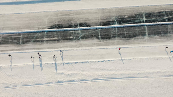 Winter ice skating on frozen lake in Luleå - aerial drone view