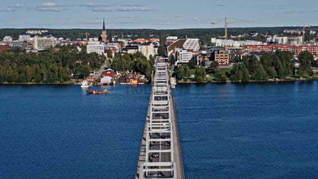 Aerial View of Luleå, Sweden: Cars Driving Across Bergnäsbron Bridge on a Summer Day