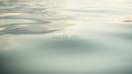 Calm Water Ripples at Sunset: Serene Golden Hour Reflections