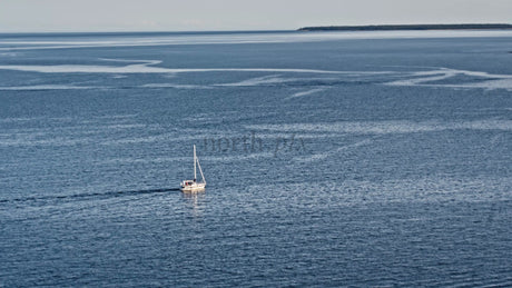 Summer Evening Sailboat in Lulea, Sweden: Calm Blue Waters and Island Views