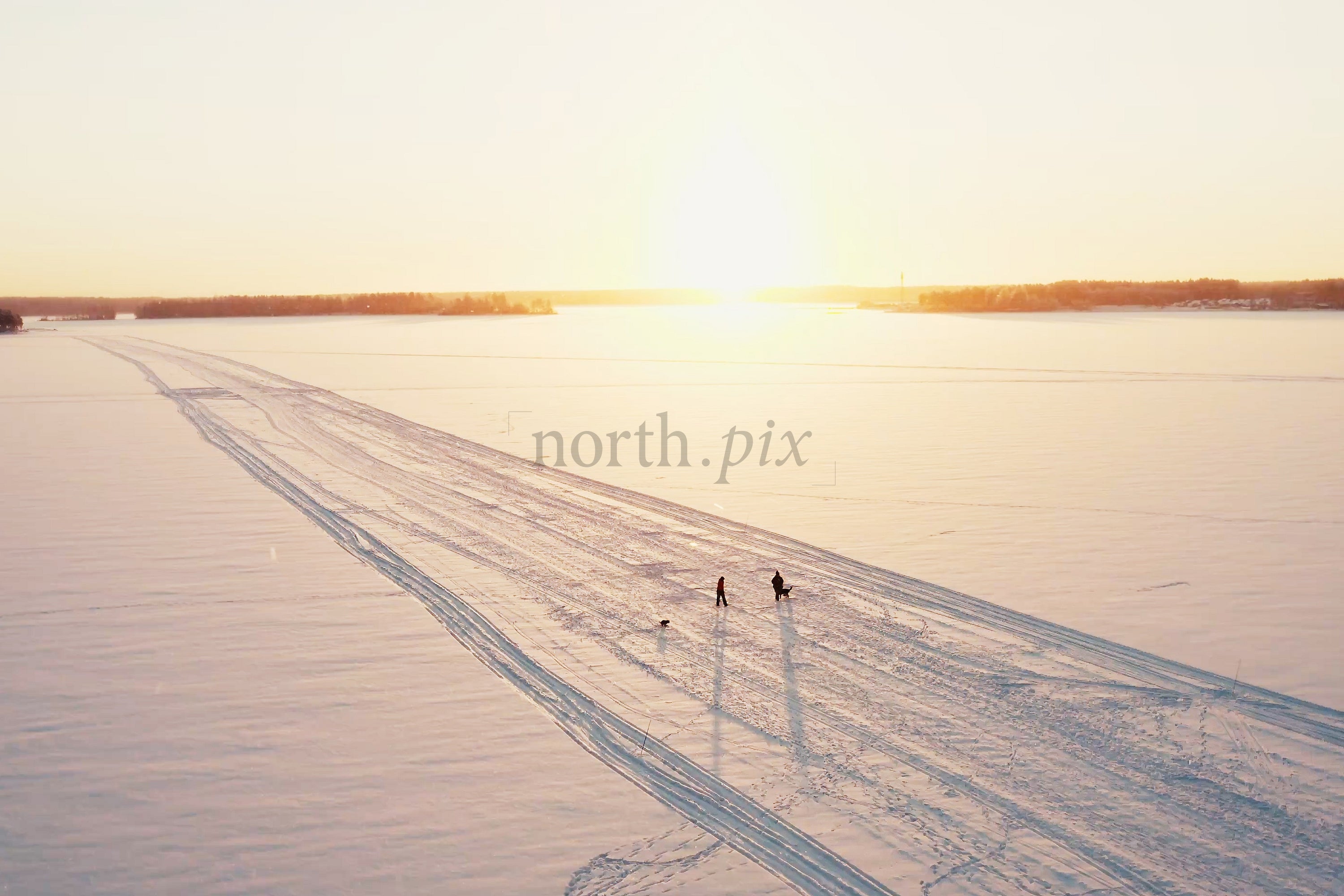 Sunset Over Snowy Luleå City Center With Tracks, People, And Open Winter Horizon