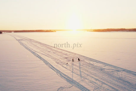 Sunset Over Snowy Luleå City Center With Tracks, People, And Open Winter Horizon