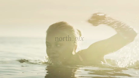 Woman Swimming in the Baltic Sea at Golden Hour in Luleå, Sweden