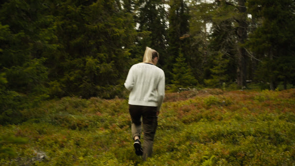 Woman hiking through a summer forest in Luleå