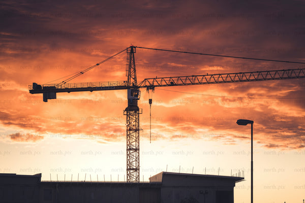 Construction crane silhouette at sunset
