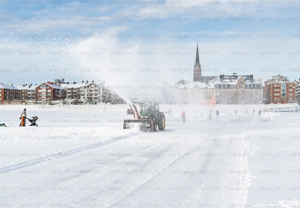 Snowplow clearing ice track on frozen sea, Luleå winter