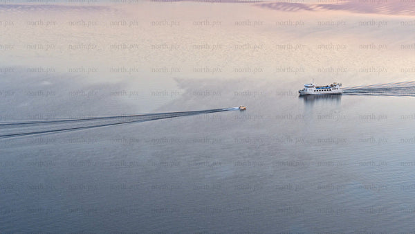 Luleå river sunset: Boats sailing on calm water