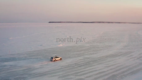 Driving on a Frozen Ice Road in the Luleå Archipelago at Sunset
