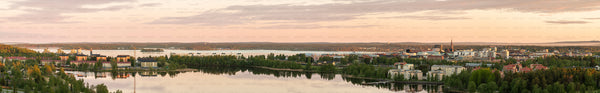 Panoramic aerial view of city skyline by a lake at evening