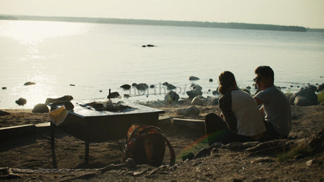 Couple Enjoys Sunset by the Lake in Lulea, Sweden: A Romantic Summer Evening