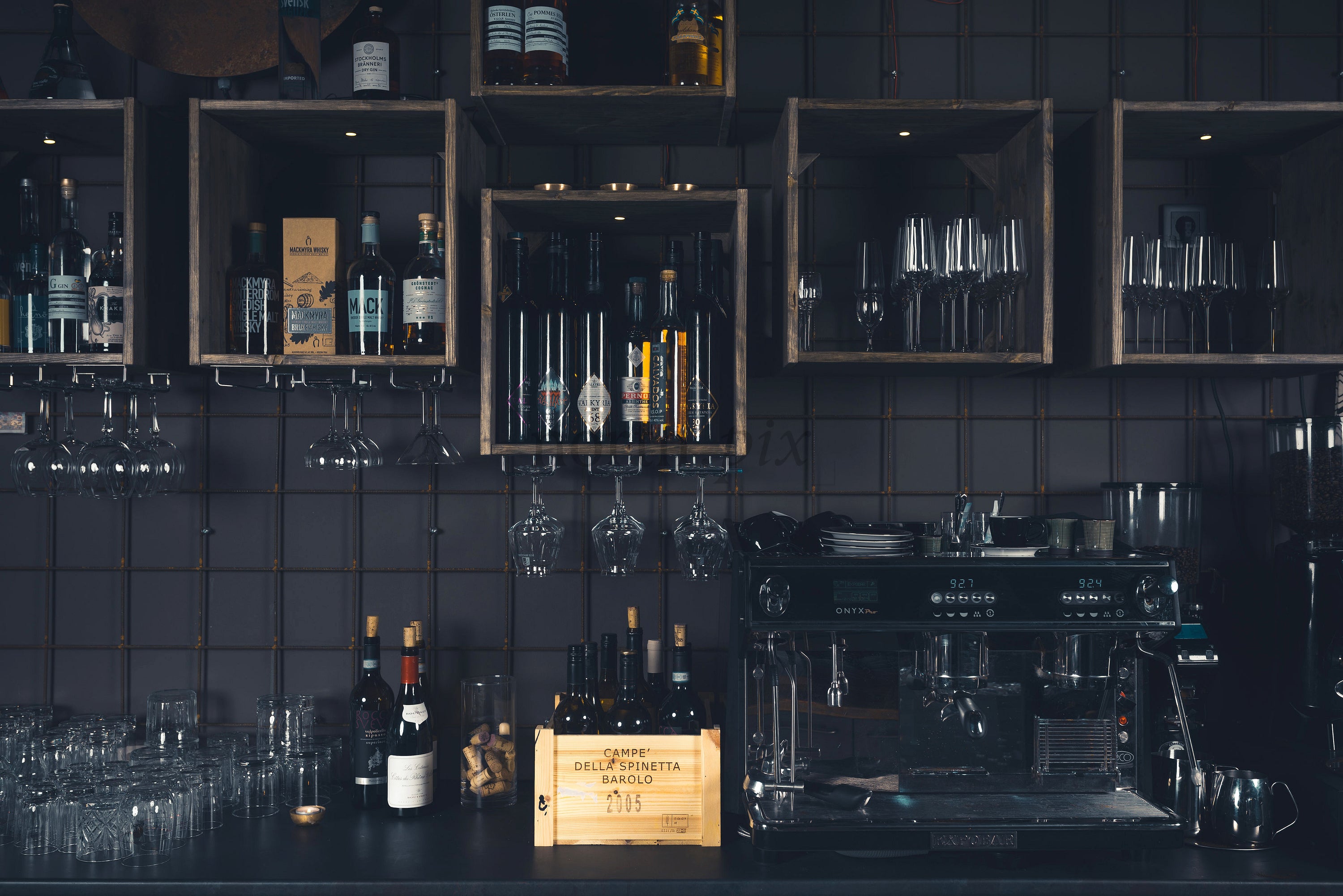 Bar counter with wine bottles and espresso machine, interior