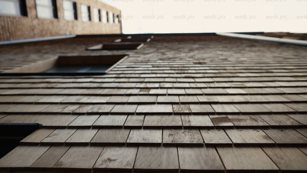 Modern wood shingle building facade: A low angle tracking shot