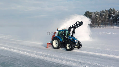Tractor Clearing Snow on Frozen Lake in Lulea, Sweden: A Winter Landscape
