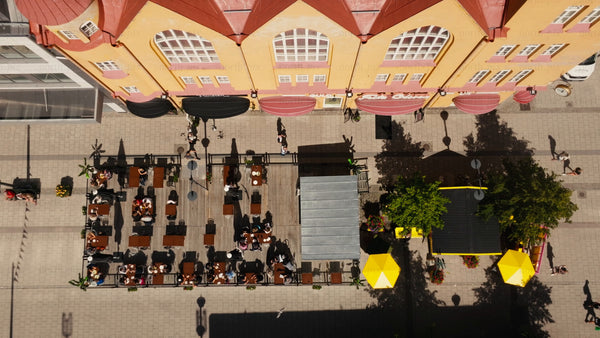 Summer in Luleå: Aerial view of city street, outdoor restaurant, and pedestrians