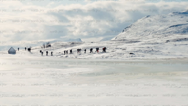 Winter hiking adventure in riksgransen, Sweden: Exploring snowy mountains and frozen lake