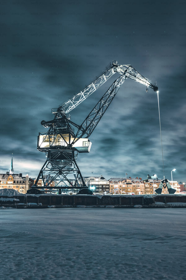 Luleå industrial harbor crane at night in snowy city