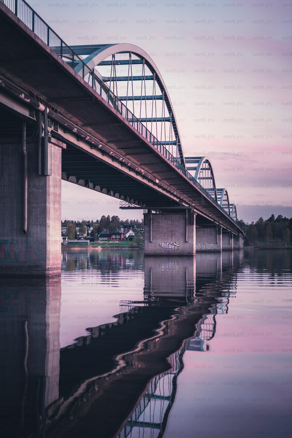 Bergnäsbron - arched bridge over river with reflection at dusk