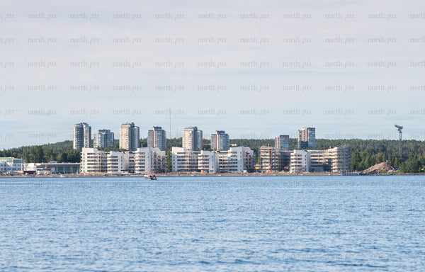 Waterfront apartment buildings on coastline at midday