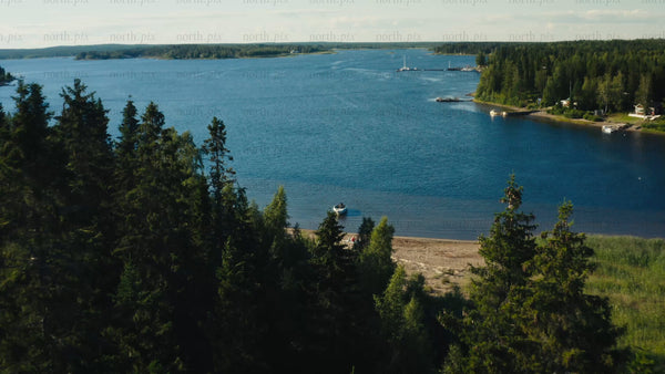 Summer in Luleå Archipelago: Drone View of Boat, Beach, and Forest