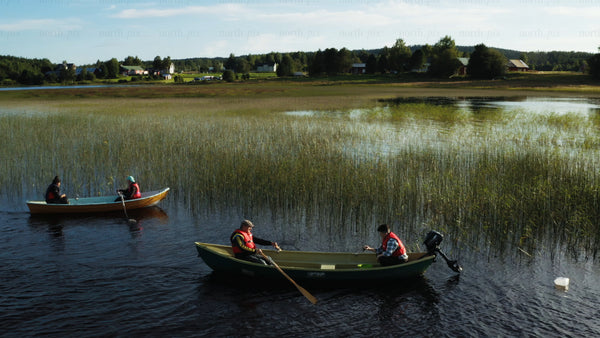 Crayfish fishing on a calm lake in Luleå, during a summer day