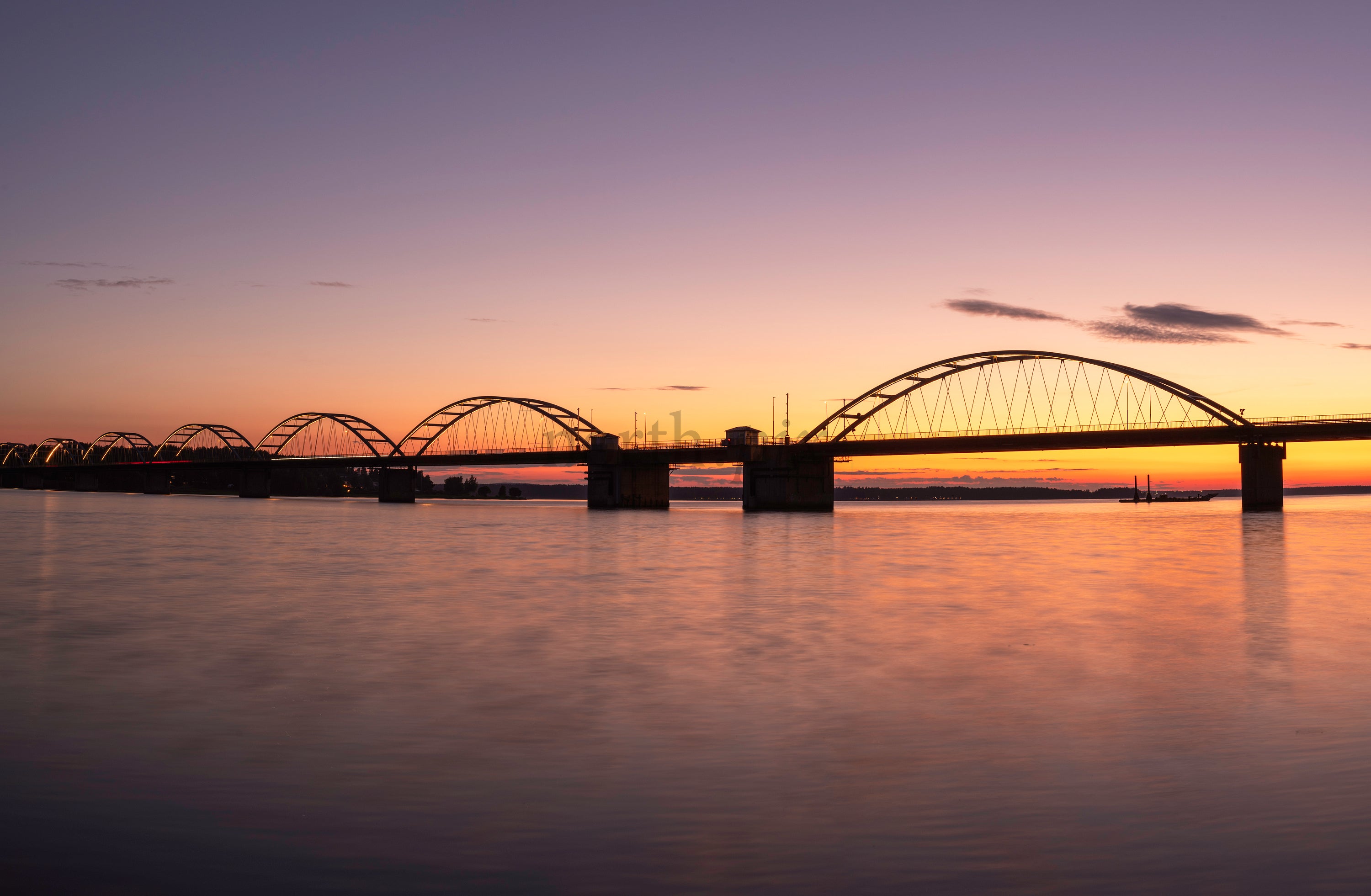 Bergnäsbron arched bridge at sunset over river