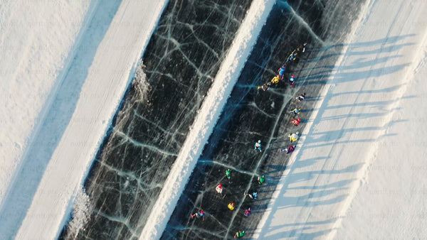 Winter Ice Skating in Luleå, Sweden: Aerial Drone View of People on a Frozen Track