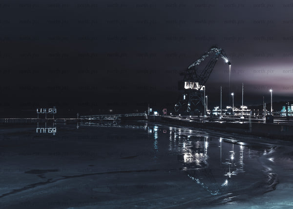 Luleå industrial harbor crane at night with reflections