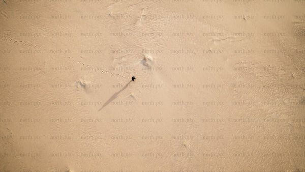 Aerial view of person walking on sandy beach in Skvalpen archipelago, Luleå