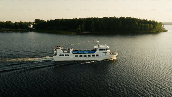 Luleå: Aerial summer evening ferry on calm lake