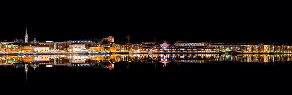 Night panorama of harbor waterfront with reflections