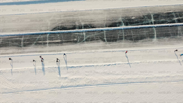 Winter ice skating on frozen lake in Luleå - aerial drone view
